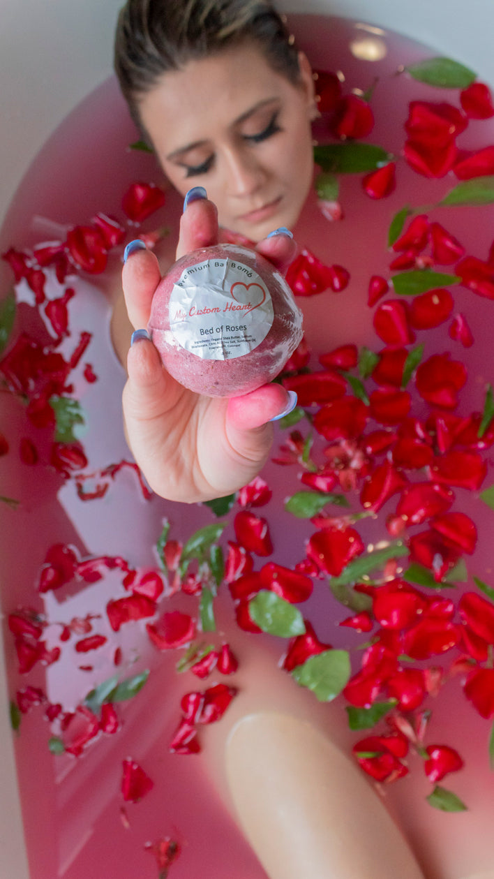 A bathbomb present shown off in a bathtub